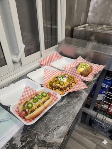 Chili dog, frito pie, and baked potato from Yabba Dabba Dogs